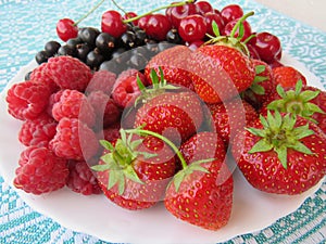 Still life of ripe berries: cherry, strawberry, currant, raspberry