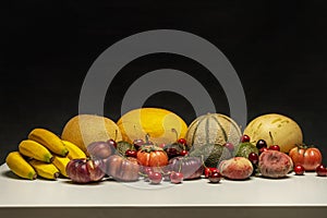 Still life with ripe melons, picota cherries, various tomatoes photo