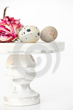 Still life with roses. Quail eggs on a wooden stand. Rustic. Easter celebration concept