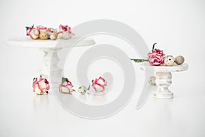 Still life with roses. Quail eggs on a wooden stand. Rustic. Easter celebration concept