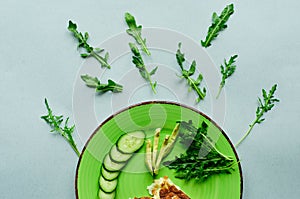 A still-life with scrambled eggs, fresh cucumbers and fried potatoes with meat. photo