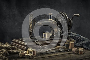 Still life with a sewing machine, scissors, threads