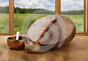 A still life of the shamanic drum and Tibetan singing bowls