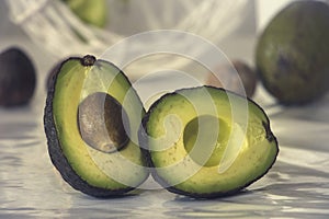 Still life with sliced avocado on white background