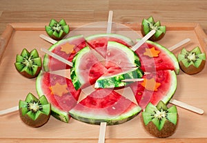 Still life, slices of watermelon, on a wooden stick. And carved kiwi.