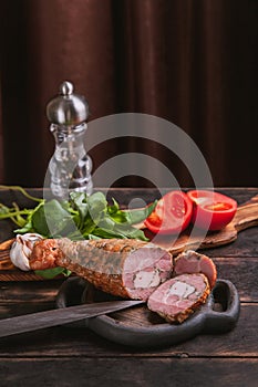 Still life with Slicing from a homemade artisan turkey meat, boiled and smoked with the addition of chicken fillet in the skin of