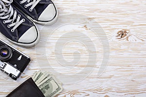 Still life with sneakers, camera and wallet