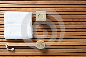 Still life with solid soap, body brush and white towel
