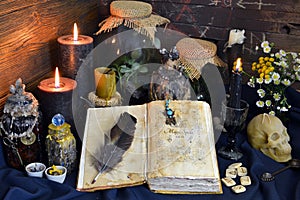 Still life with spell book, magic jars with plants and potion on witch table