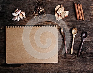 Still life with spices and notebook paper on wood