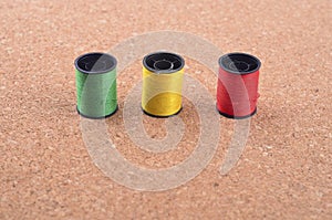 Still life of spools of thread on a wooden background