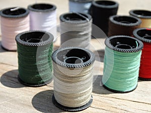 Still life of spools of thread on a wooden background