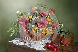 Flowers of Tulips and daffodils in a basket .