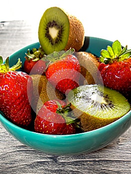 Still life of strawberries and kiwis on the table