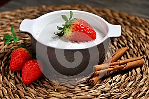 Still life of a strawberry on a jar full of sugar