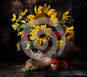 Still life with sunflowers and autumn flowers in a vase