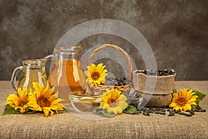 still life with sunflowers harvest. sunflower oil. seeds in a basket