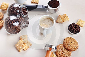 Still life with sweets, cup of espresso, coffee beans and ground coffee on table