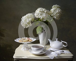 Still life with tea and bouquet of hydrangea flowers