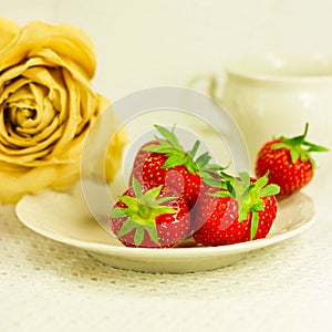 Still-life with tea set, dry rose and strawberry