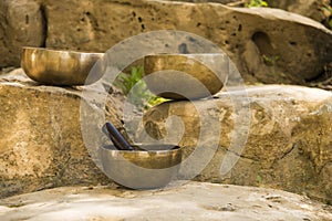 Still life with Tibetan bowls on rocks