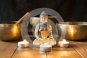 Still life with Tibetan singing bowls, minerals, candles and a Buddha figure