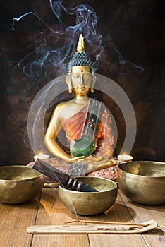 Still life with Tibetan singing bowls, minerals, candles and a Buddha figure