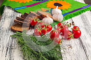 Still life: tomatoes, black bread, garlic, fennel, bayberry pep