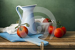 Still life with tomatoes and enamel jug