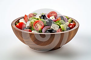 Still life traditional Greek salad presented beautifully in rustic wooden bowl. Salad boasts vibrant colors with crisp c