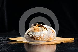 Still life with a traditional round artisan rye bread loaf with