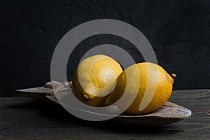 Still life with two lemons. Dark style