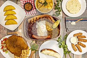 Still life of typical Colombian and Venezuelan recipes, bandeja paisa, corn empanadas, chicken clade, arepas and tequeÃ±os and