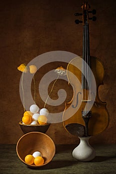 Still life with violin, white and orange balls and sliced â€‹â€‹lemon