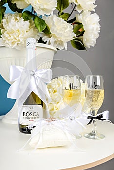 Still life with wedding rings, flowers, champagne