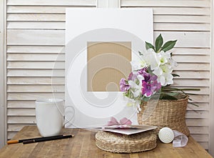 still life with a white frame, cup and a nice flower's