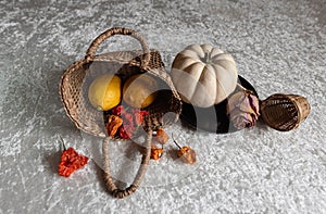 still life on a white tablecloth, fruit in a wicker basket and other objects