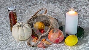 still life on a white tablecloth, fruit in a wicker basket and other objects