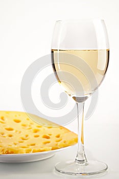 Still life with white wine and cheese