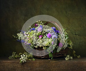 Still life with wild flowers in basket