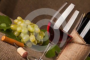 Still life with wine bottles, glasses and grapes