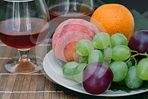 Still life: wine by the glass and fruit.