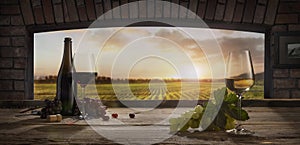 Still life with wine glasses, bottles, grapes on wooden table in wine cellar. Panoramic window view of lush vineyards at