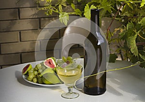 Still life - wine,grapes and figs outdoors.
