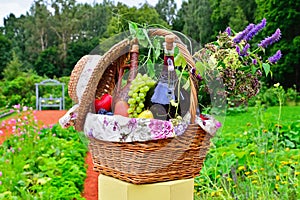 Still life: wine, grapes, flowers and vegetables in the basket o