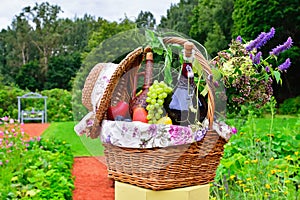 Still life: wine, grapes, flowers and vegetables in the basket o