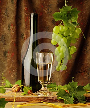 Still life with wine and hanging grape