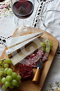 Still life with wine, soft cheese