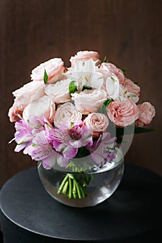 Still life. a wooden antique table, glass vase with Mixed bouquet. beautiful flowers