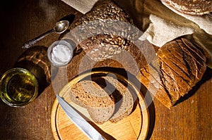 Still life - yeast-free buckwheat bread, various types of black bread, with olive oil and coarse salt in glass jars, a
